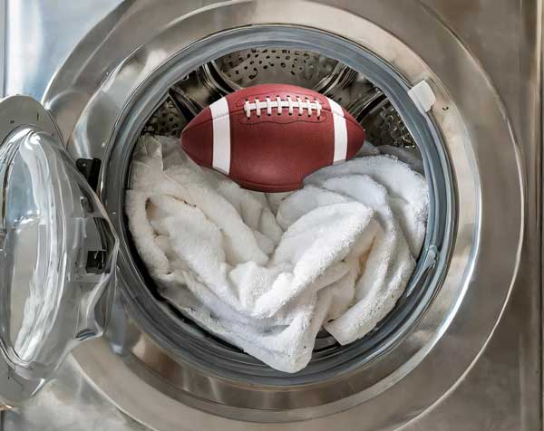 Good comforter cleaning with a football on top of a white comforter