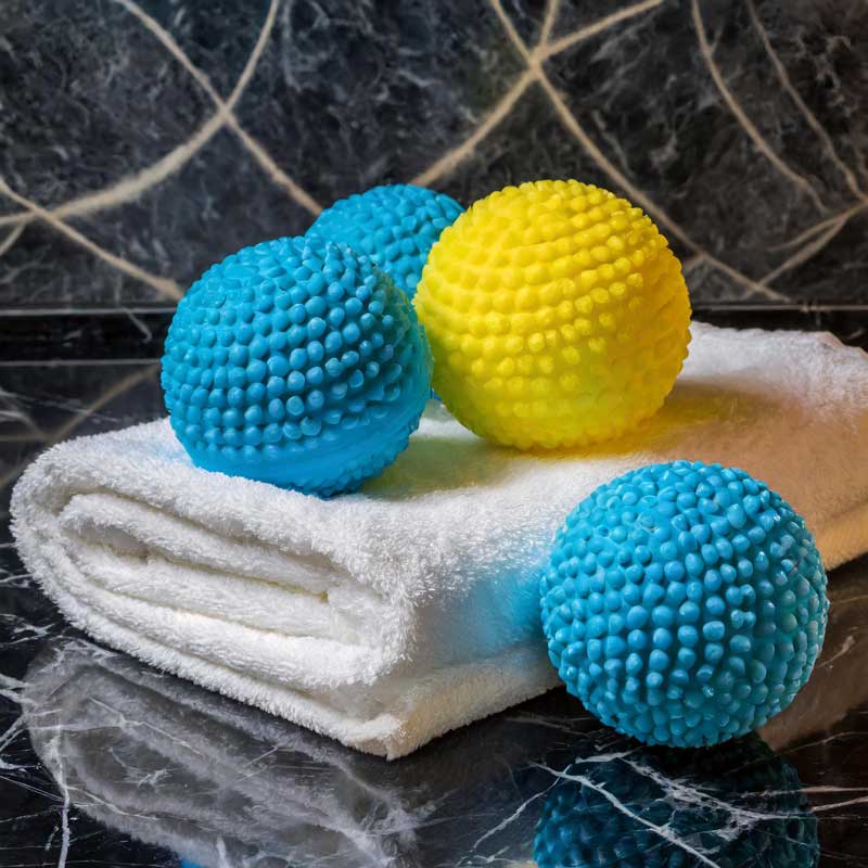 Yellow and teal dryer balls help with comforter cleaning